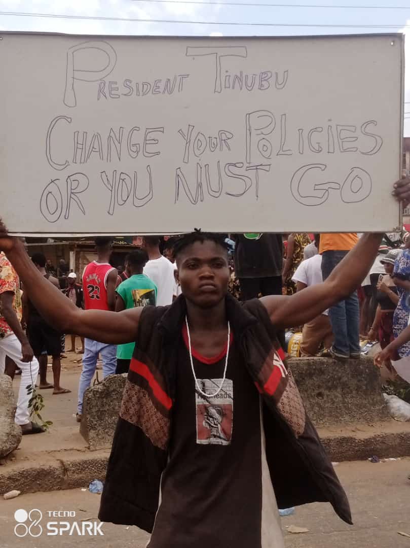 Protest displaying placard: photo credit: Michael Ikechukwu